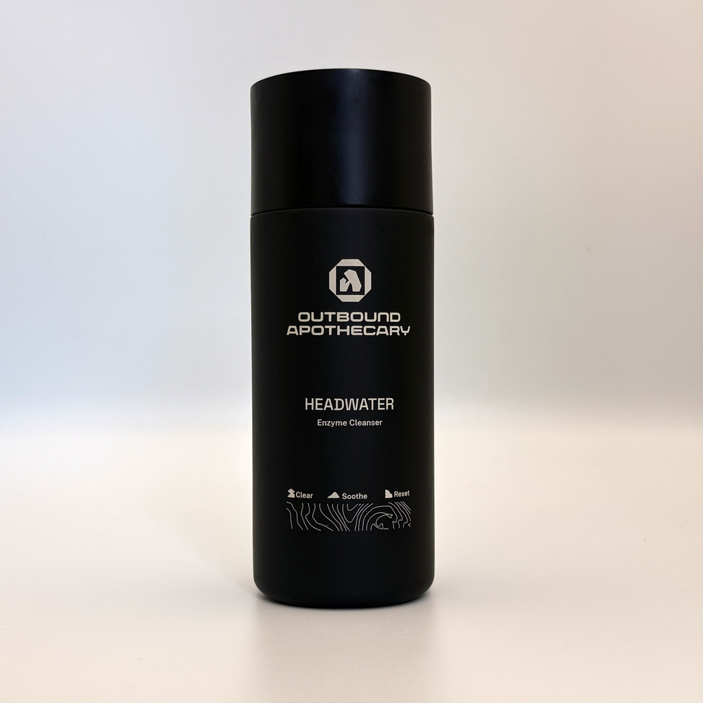 Black bottle with 'Outbound Apothecary' branding on a light background