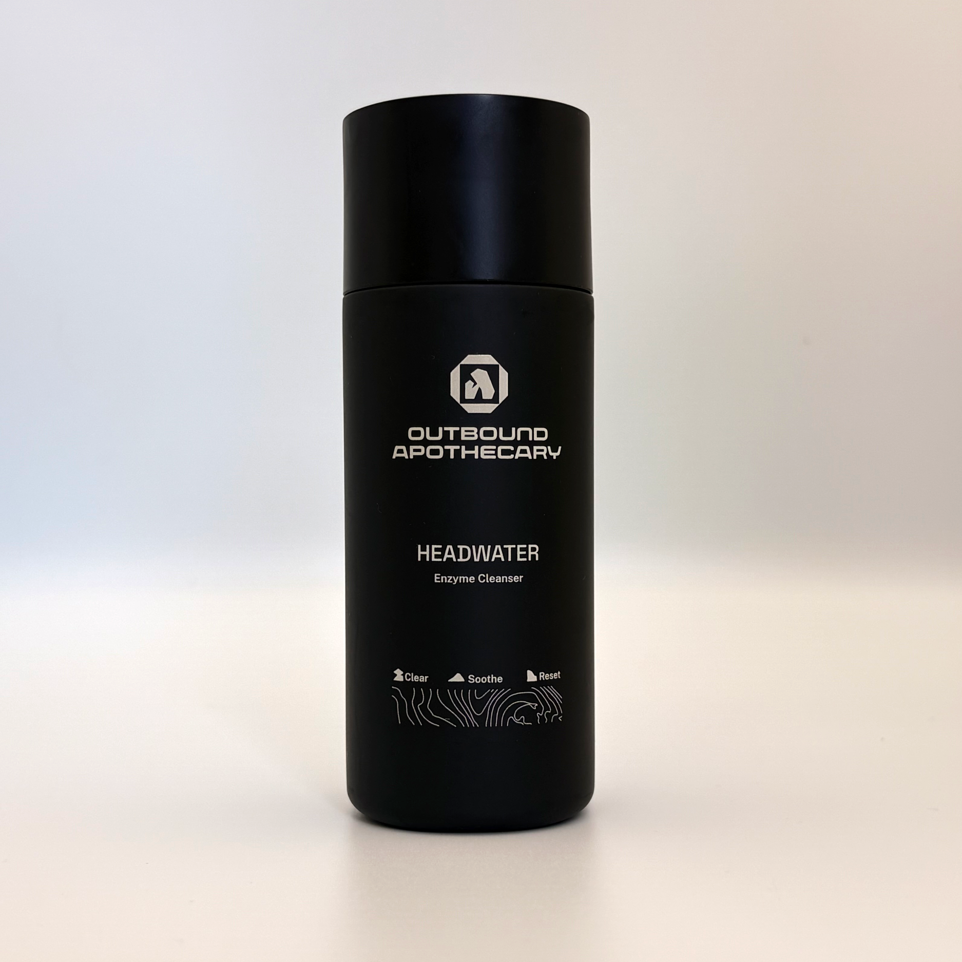 Black bottle with 'Outbound Apothecary' branding on a light background