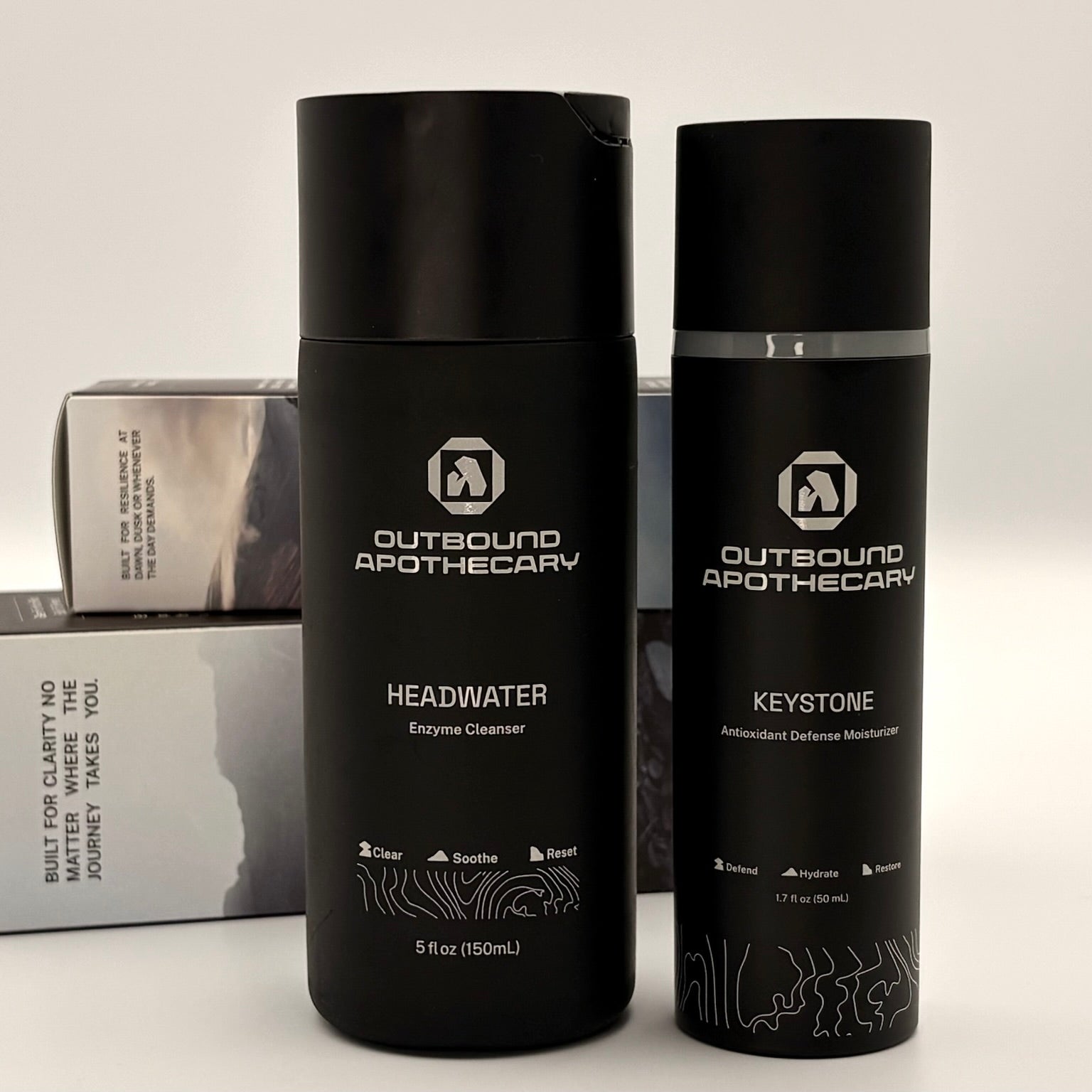 Two black bottles labeled 'Outbound Apothecary' on a light background