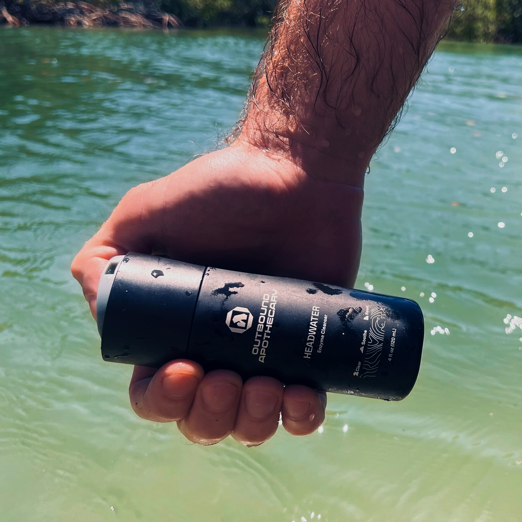 Hand holding headwater cleanser in a lagoon